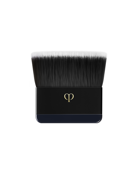 Photo of a flat brush designed specifically for "RADIANT POWDER FOUNDATION". The handle is engraved with the brand logo in gold.