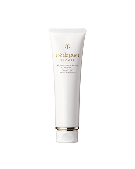 Photo of a white tube of &ldquo;CLARIFYING CLEANSING FOAM.&rdquo; Gold brand logo and product name are printed on the front. The cap features gold detailing. Size: 140g.