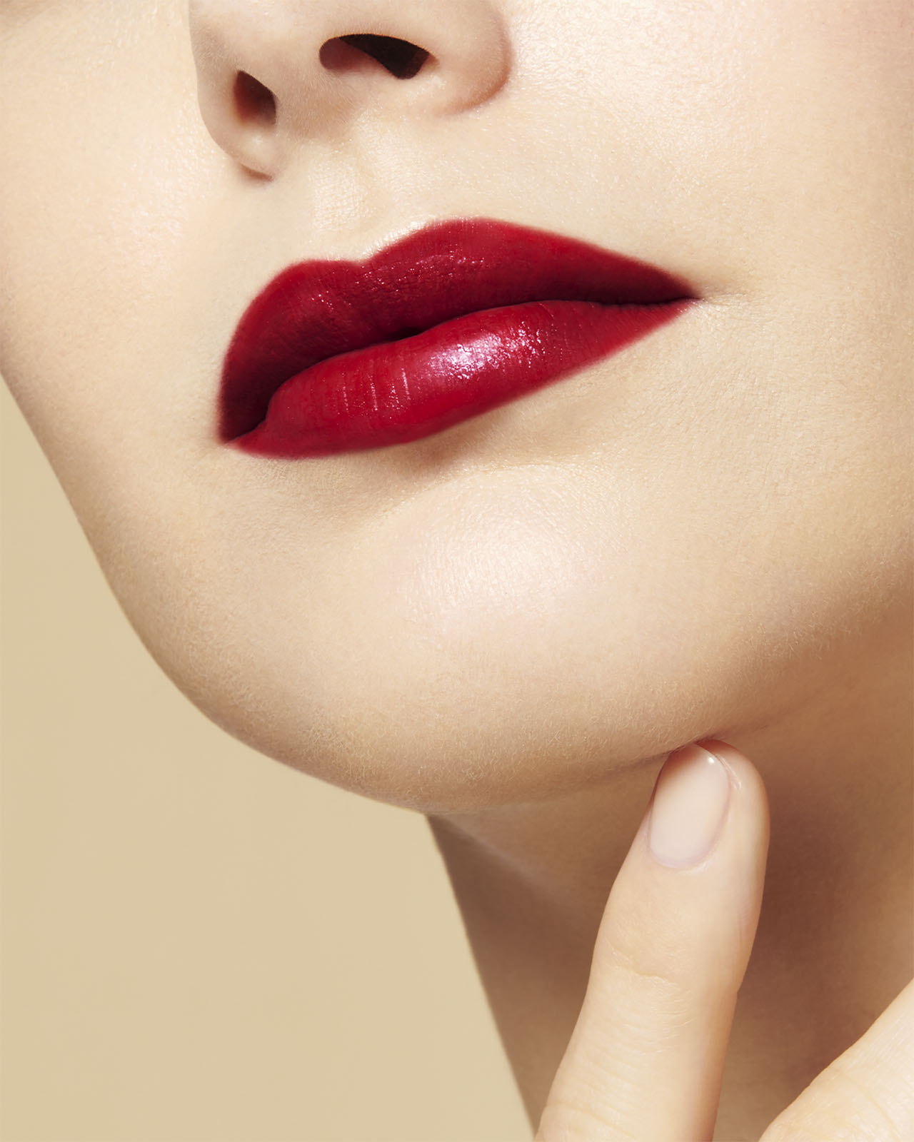 Photo of a light skin tone model wearing "THE PRECIOUS LIPSTICK" on the lips, shown from a different angle.