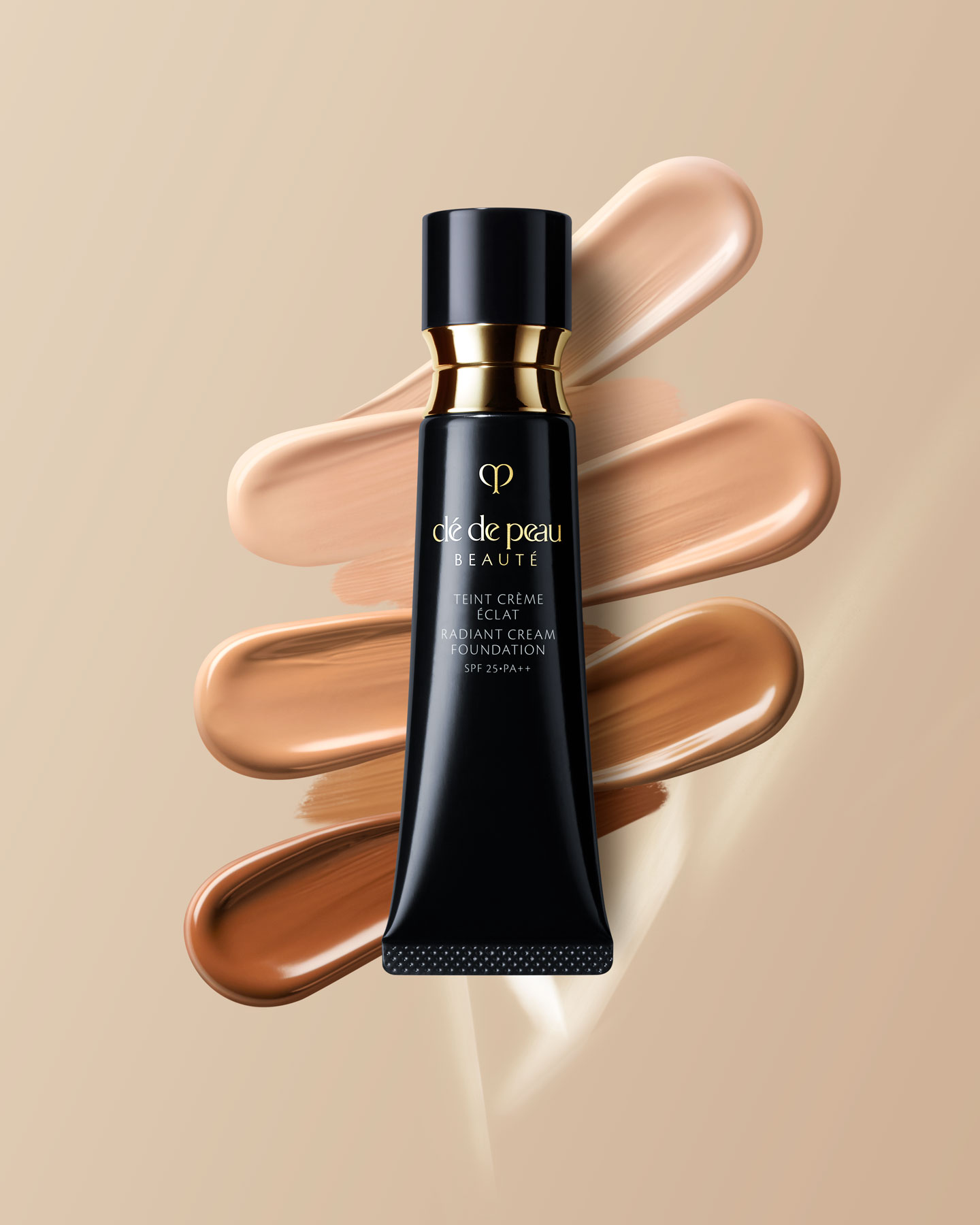 Photo of a blue-black tube of RADIANT CREAM FOUNDATION with gold accents.