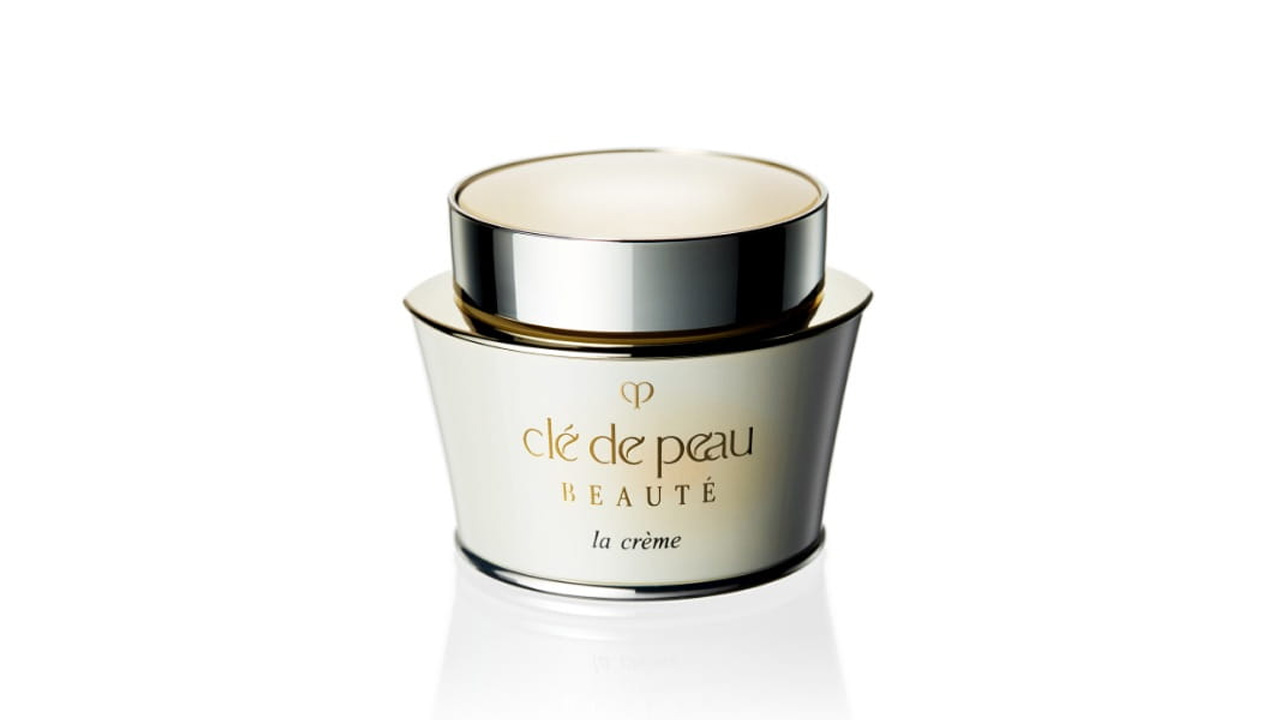 相片顯示淡米色瓶身搭配銀色瓶蓋。前方印有品牌標誌和文字「la cr&egrave;me」（舊包裝）。